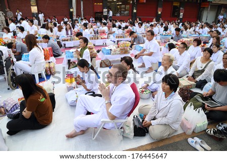NAKHON RATCHASIMA, THAILAND - FEB 8: People waiting for give food offerings to Buddhist monks in the occasion celebrating 357-year anniversary of Nakhon Ratchasima city in Nakhon Ratchasima, Thailand