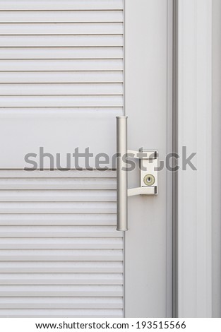 metallic knob on white door