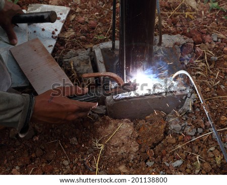 worker us electric welding connecting construction metal