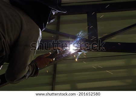 worker us electric welding connecting construction metal