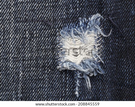 close up of torn old blue jeans