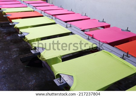 prepare colorful t-shirt on screen table
