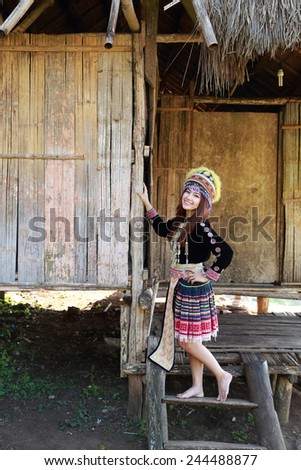 Traditionally dressed Mhong hill tribe woman in the wooden cottage