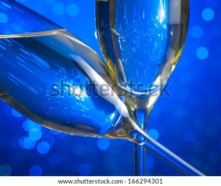 detail of champagne flutes on blue light bokeh background