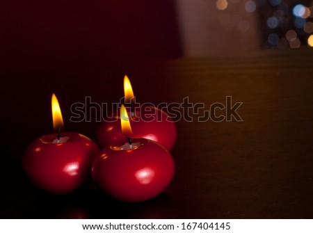 top of view of red christmas candles on wood table on warm tint light and bokeh background with space for text