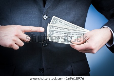 detail of businessman with dollars in his hand on blue background, concept for business and earn money