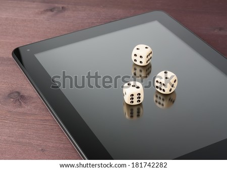 dice on digital tablet pc on old wood table, concept of texas game online