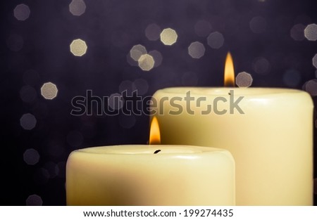 close-up of candles with flame on bokeh background and space for text
