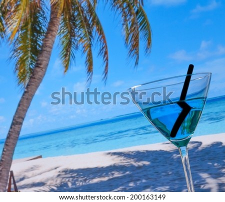 blue cocktail on beach, blue sea and sky background