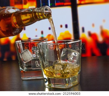 barman pouring whiskey on bar table lounge bar atmosphere