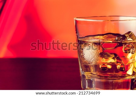 whiskey glass with ice on bar table lounge bar atmosphere with space for text