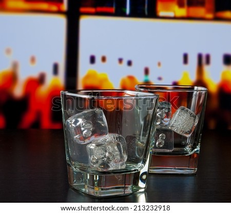 empty whiskey glasses with ice on bar table lounge bar concept