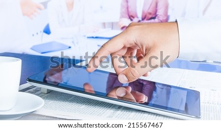 business man touch on a digital tablet in the reunion
