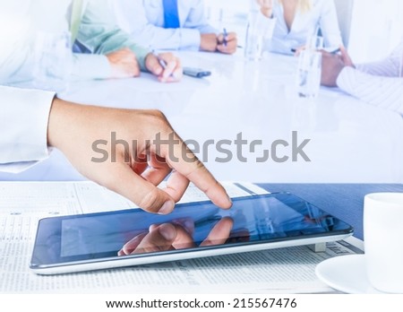 business man working with a digital tablet in the reunion