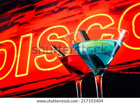blue and red cocktail with neon disco word background with space for text, dance disco concept