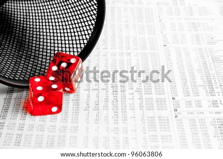 detail of two red dice on the financial newspaper
