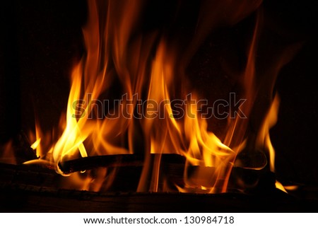 Fire in a fireplace, fire flames on a black background