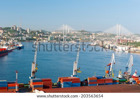 Front view of  russian port Vladivostok against the downtown and new bridge over Golden Horn bay