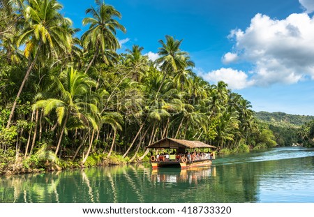 traditional raft boat on a jungle green river Loboc at Bohol island of Philippines
