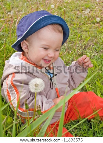 happy kid on the dandelion meadow