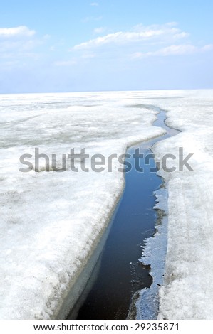 arctic solid ice landscape with track of ice-breaker ship