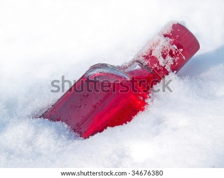 red vodka bottle in the snow