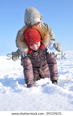 happy family of mother with baby playing in the snow