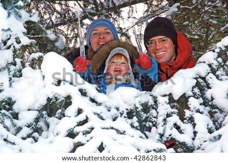 happy family in the snow fir tree
