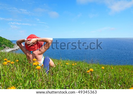 happy girl on the flower meadow against the sea   landscape
