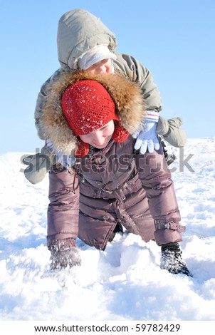 happy family of mother with baby playing in the snow