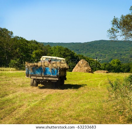 stock photo russian farmer riding old truck fully covered by hay