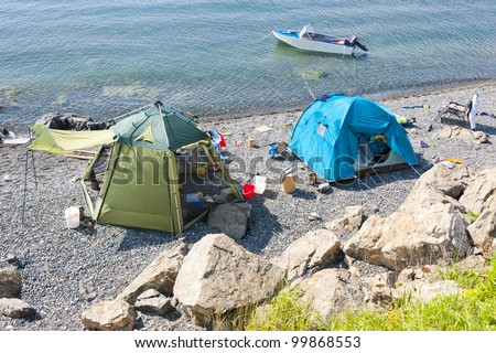 wild tourist camping on desert beach on the russian reserve isle Reinike
