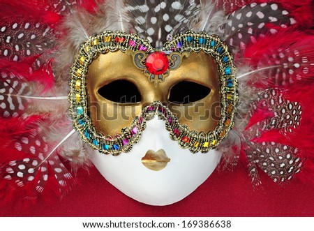 Red carnival mask with feathers