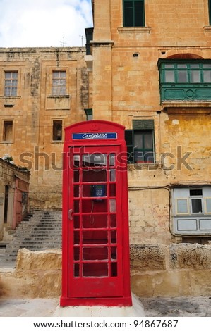 Traditional red telephone booth on street of Valletta, Malta