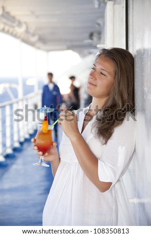 Girl with a cocktail on the deck of dreams day