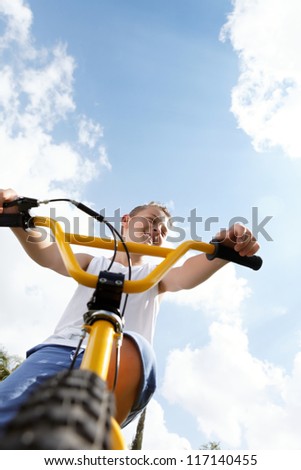 boy on a bike outside in the afternoon