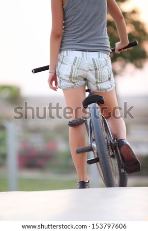 Girl with a bicycle, a summer day
