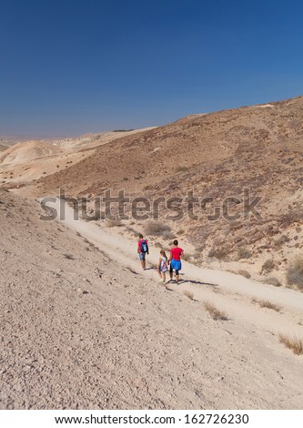 a family traveling in the desert summer day