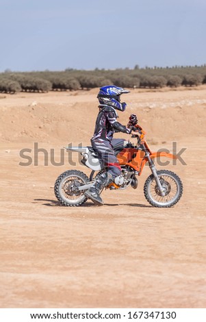 racing motorcycles for teenagers on desert area, summer day
