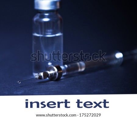 syringe with the vial on a dark background, medicine