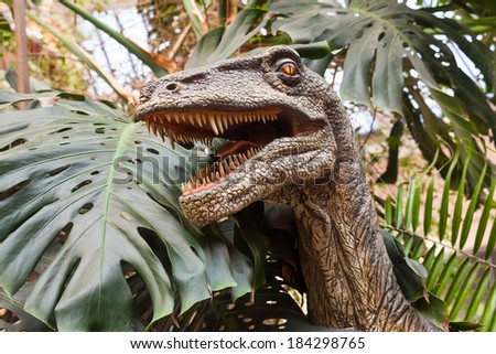 portrait of dinosaur figures in a wooded park