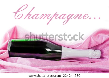 closed bottle of champagne wrapped in pink tissue