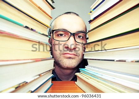 portrait of a man wearing glasses a lot of books