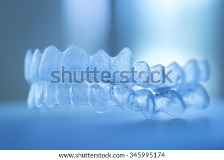 Invisible dental teeth brackets tooth aligners plastic braces retainers to straighten teeth. Orthodontic temporary removable straighteners in dental office dentists surgery