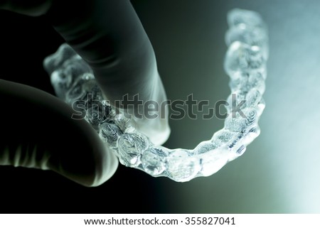 Invisible dental aligners modern tooth brackets transparent teeth braces to straighten teeth in cosmetic dentistry and orthodontics.