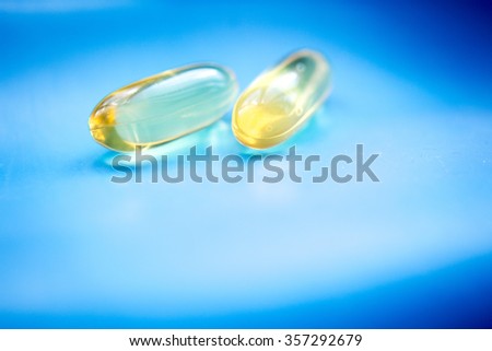 Cod liver fish oil omega 3 6 9 capsules health food suplement vitamin and mineral pills photo.