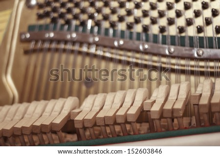 Playing piano strings and hammers close up
