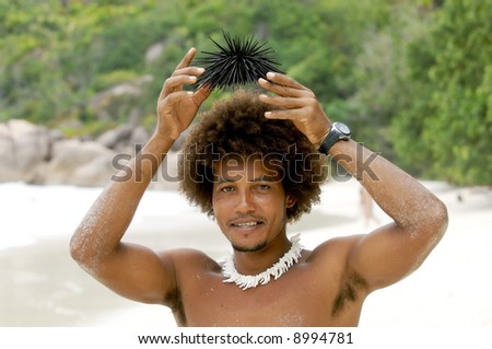 holds above a head of a sea hedgehog