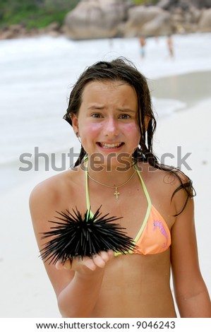 The girl for the first time holds a sea hedgehog