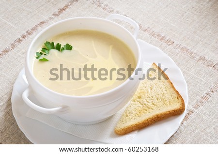 Soup in a cup with a bread slice